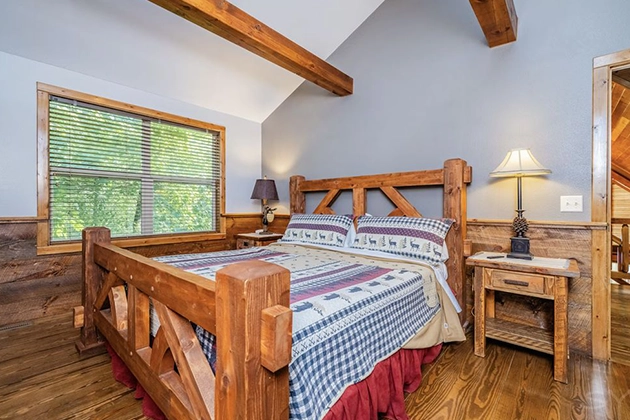 Rustic log cabin rental surrounded by trees near Devil’s Lake shoreline