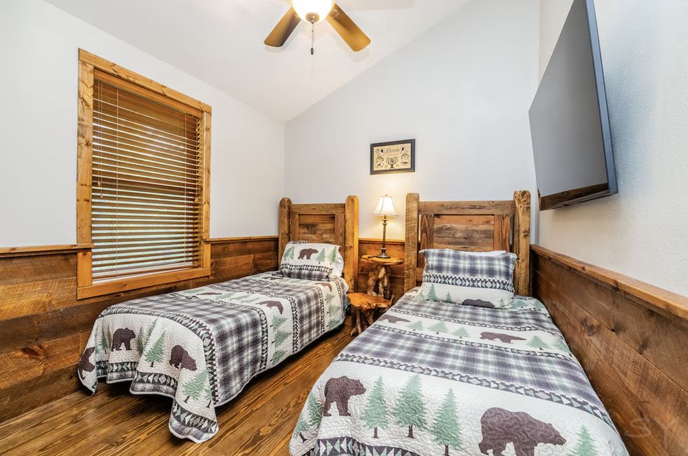 Family relaxing on cabin porch, surrounded by trees at Wisconsin vacation rental